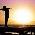 Woman at beach at sunset