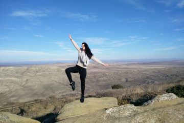 Lady balancing on a rock