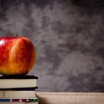 An apple on top of books