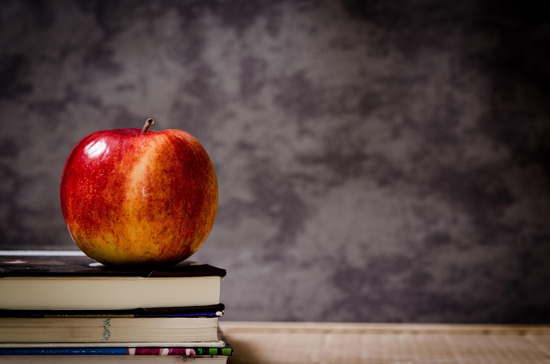 An apple on top of books